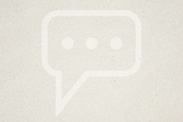 Comment icon on sand background and textured — Stock Photo, Image