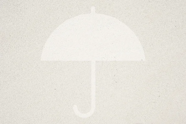 Umbrella icon on sand background and textured — Stock Photo, Image