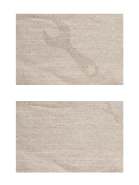 Значок гаечного ключа на бумажном фоне и текстуре — стоковое фото