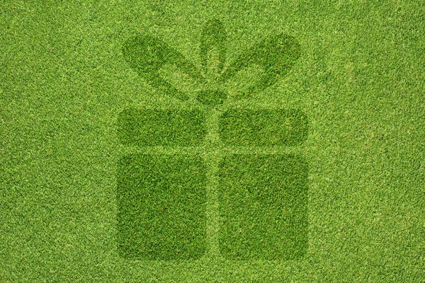 Kerst cadeau vak pictogram op groen gras achtergrond — Stockfoto