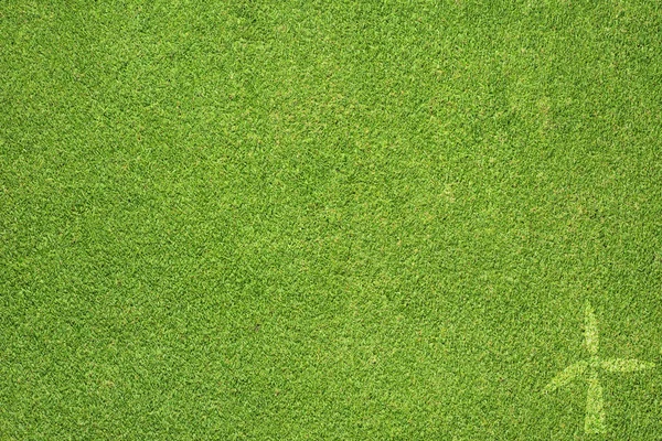ไอคอนกังหันลมบนพื้นหลังหญ้าสีเขียว — ภาพถ่ายสต็อก