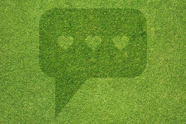 Comment icon on green grass background — Stock Photo, Image