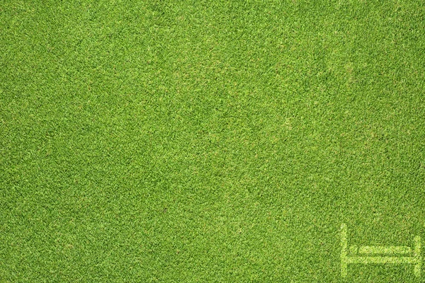 Ícone da cama na textura de grama verde e fundo — Fotografia de Stock