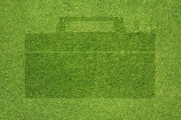 Bag icon on green grass texture and background — Stock Photo, Image