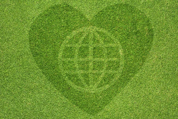 Globální ikonou srdce na zelené trávě — Stock fotografie