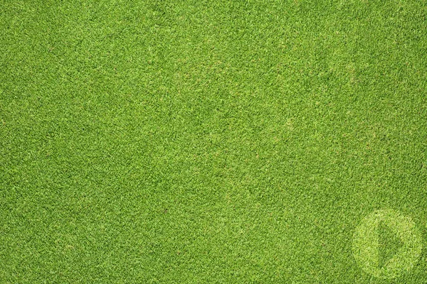 Play icon on green grass texture and background — Stock Photo, Image
