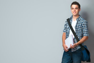 Smiling teenager with a schoolbag