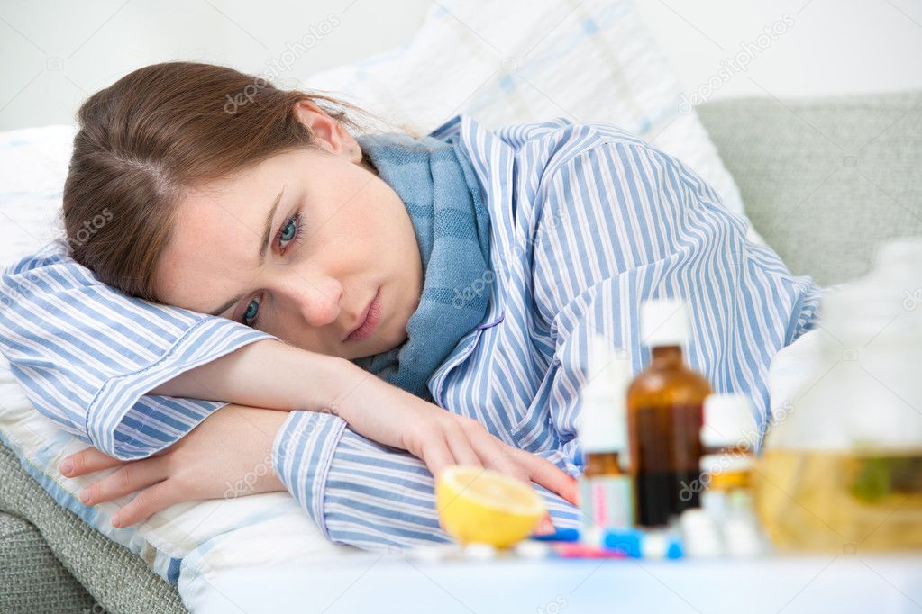 Sick woman lying in bed