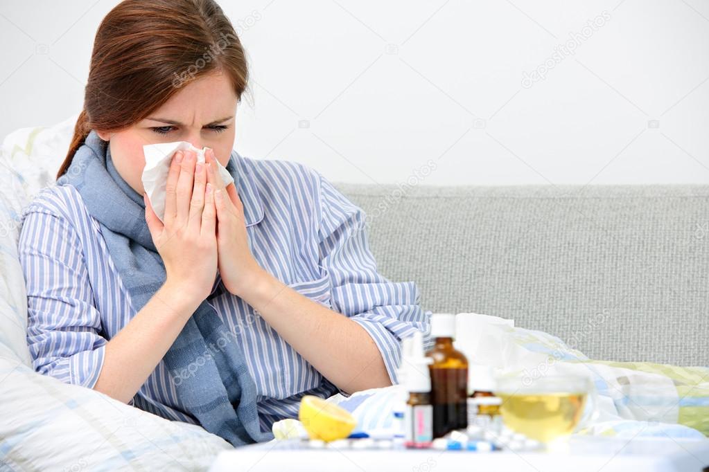 Sick woman lying in bed