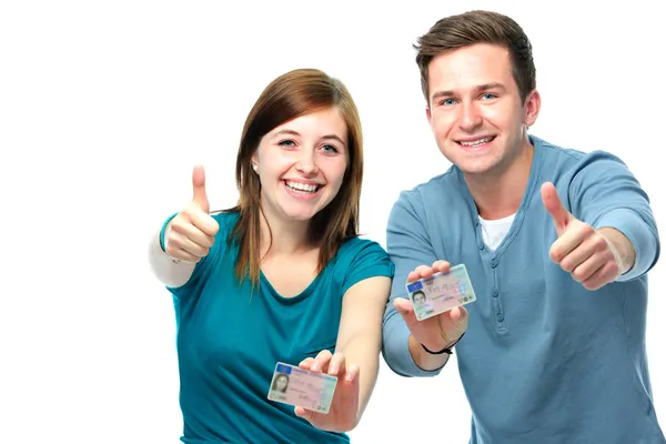 Happy teens showing their driving license — Stock Photo, Image