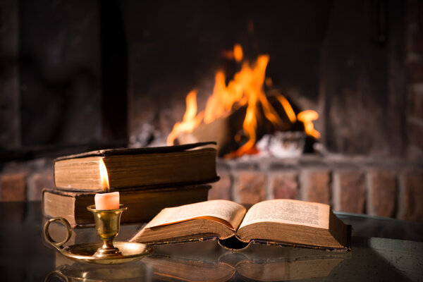 Bible with a burning candle
