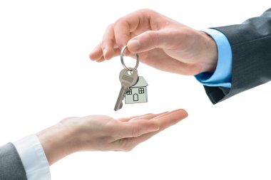 Man is handing a house key to other hands clipart