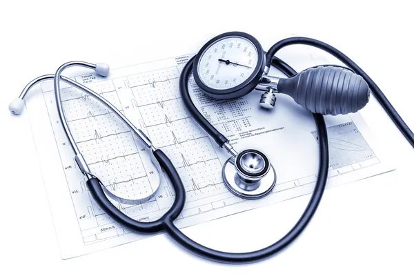 Medical tools lying on ECG — Stock Photo, Image