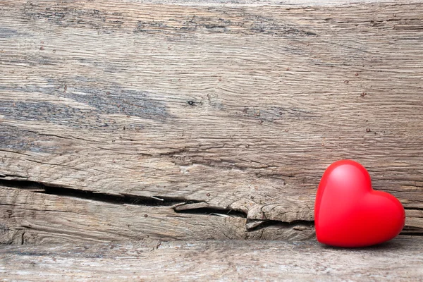Coração vermelho em rachadura de prancha de madeira — Fotografia de Stock