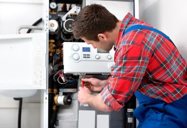 Technician servicing heating boiler clipart