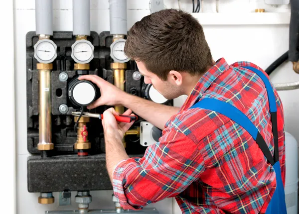 Technician servicing heating boiler — Stock Photo, Image