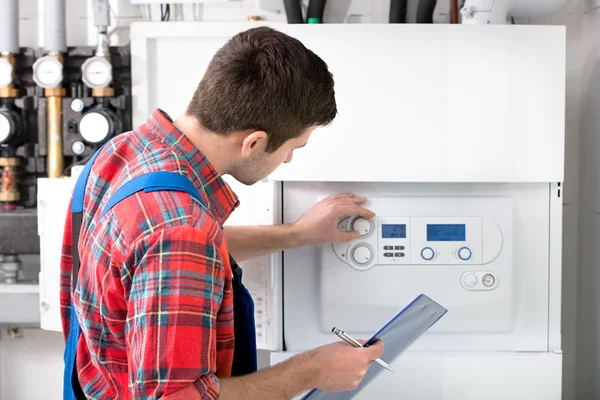 Technician servicing heating boiler — Stock Photo, Image