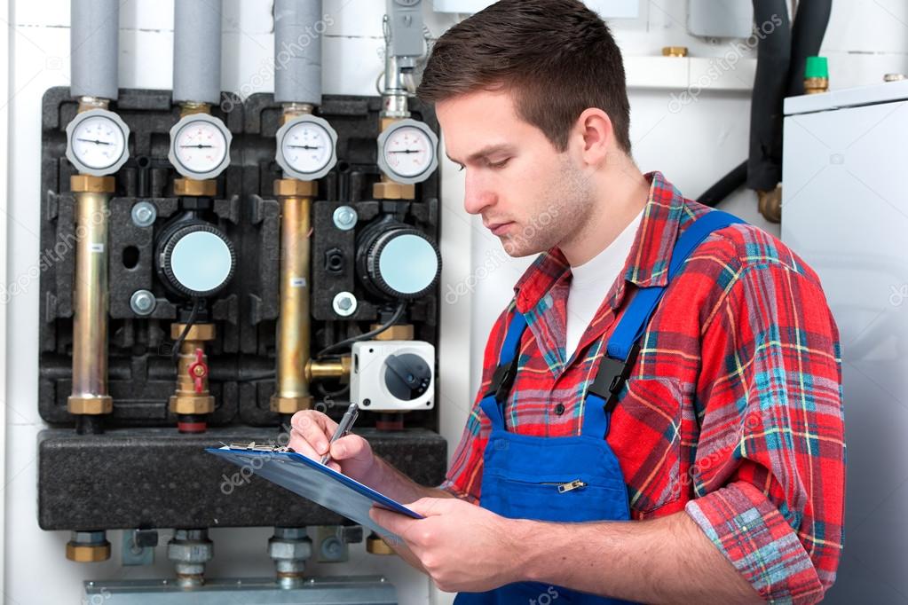 Technician servicing heating boiler Stock Photo by ©alexraths 42796459