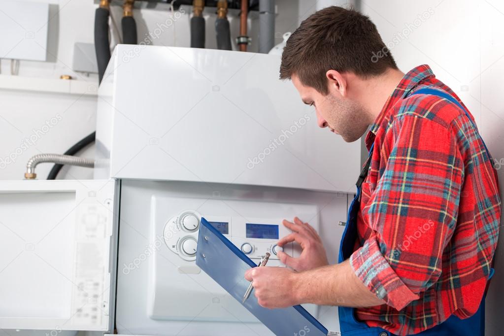 Technician servicing heating boiler