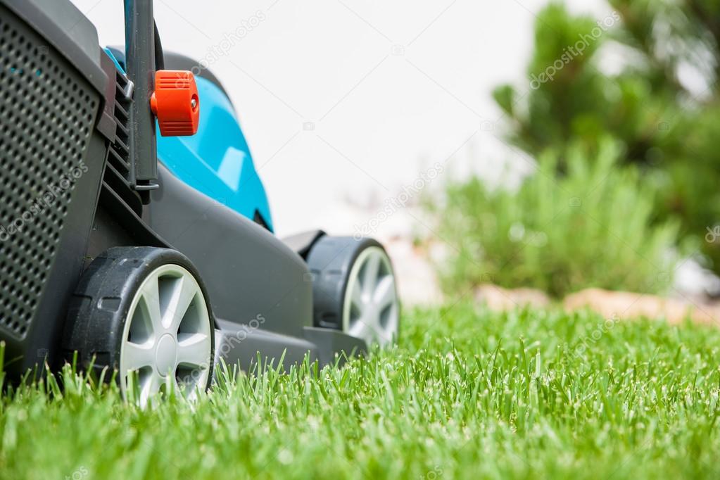 Lawn mower on a green meadow