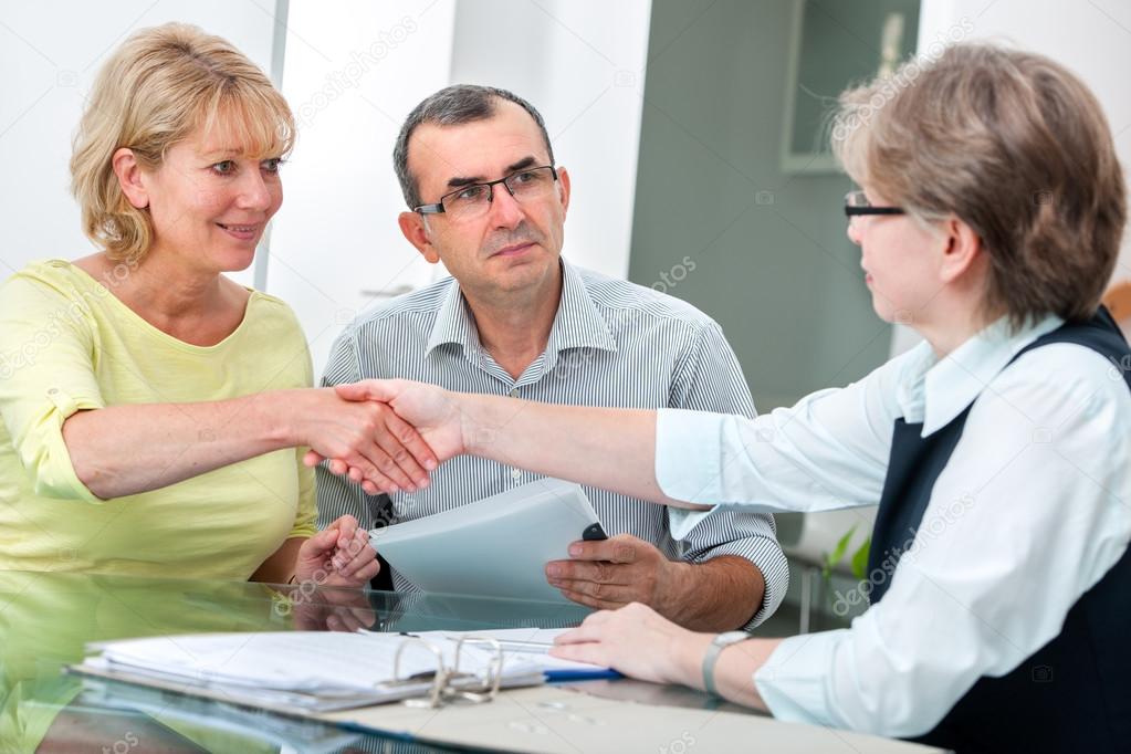 Couple talking with financial advisor