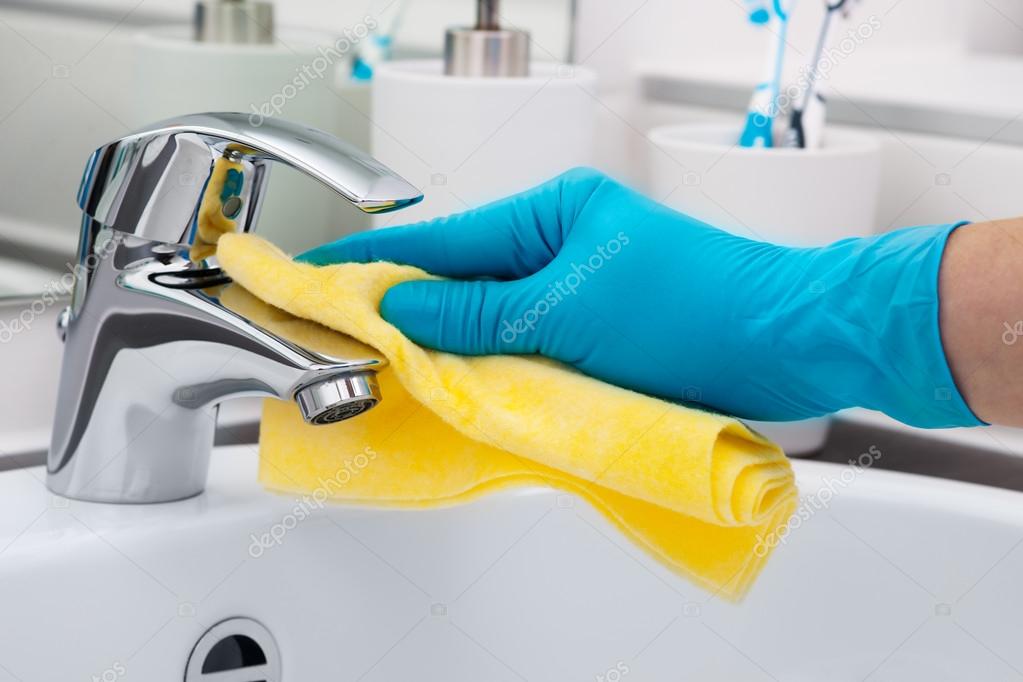 Download Woman doing chores in bathroom, cleaning tap — Stock Image