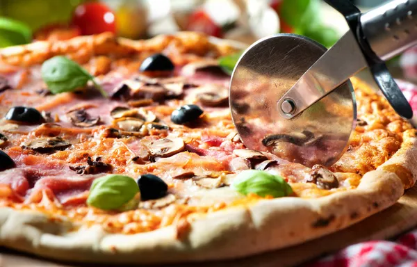 Pizza Cutter Wheel Slicing Pizza Tomato Sauce Cheese Ham Olives — Stock Photo, Image