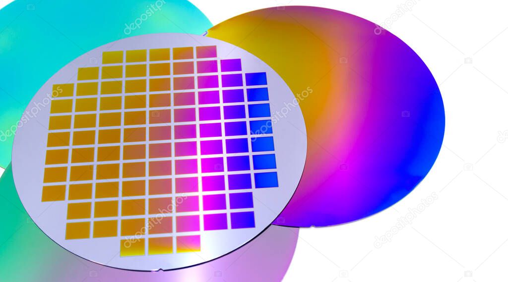 Several silicon wafers with printed circuit and different color.White background