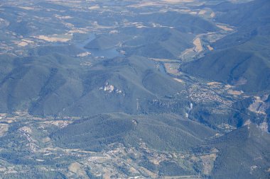 aerial shot, from a small plane, of Marmore waterfall among green woods with Piediluco lake in background, shot from north in bright summer light, Apennines, Terni, Umbria,  Italy