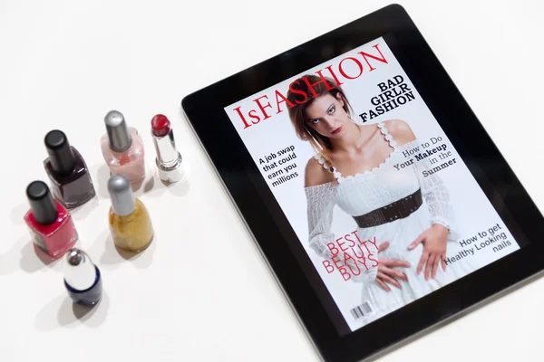 Fake fashion magazine cover on a tablet and nail polish — Stock Photo, Image