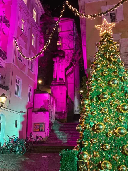 Modern Christmas tree.  Streets lit with pink light.  Taken in Baden-Baden, Germany.