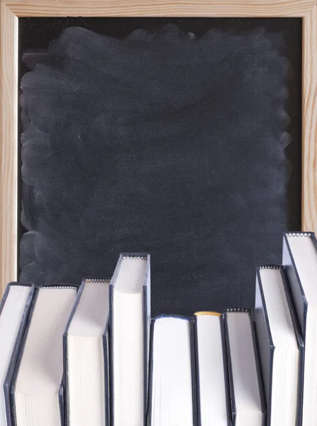 Hardcover books with chalkboard background — Stock Photo, Image