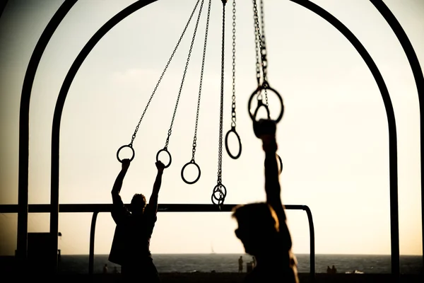 Tourists swinging on rings — Stock Photo, Image