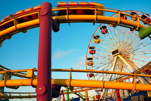 Amusement park rides on a pier — Stock Photo, Image