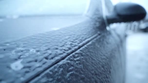 The icy car body close-up. Ice covered the car after rain in winter — Vídeo de Stock