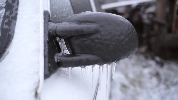 Plastic black rearview mirror covered with ice close-up on white car — Stock Video