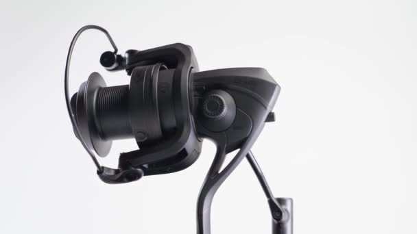 Kiev, Ukraine - January 8,2022: NASH BP-10 spinning reel with fishing line spinning on a white background close-up — Stock Video