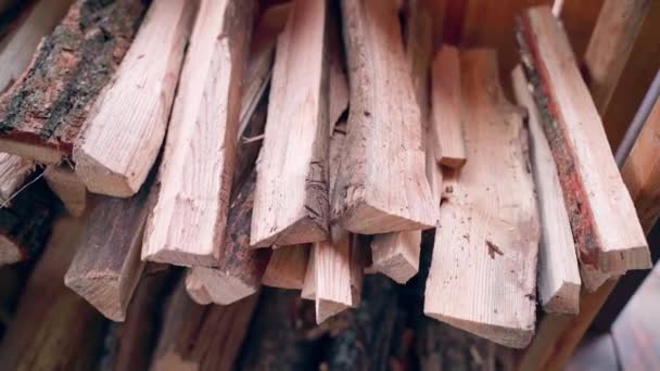 Neatly stacked firewood on a wooden rack on the terrace — Stock Video