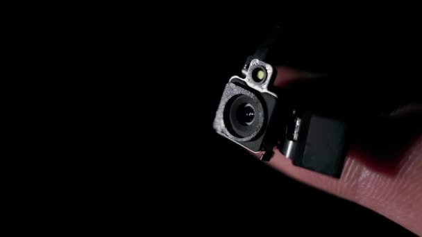 A hidden camera module that fits on a finger on a black background disappears — Stock Video