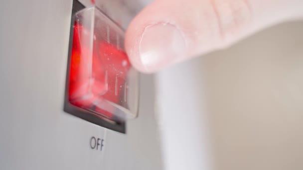 Turning on and off the two red buttons of the boiler close-up. Moisture protection of buttons on household appliances, water heater — Stock Video