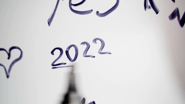 2022 라는 숫자는 유리판에 검은 마커와 함께 스케치되어 있다 — 비디오