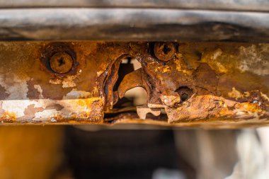 Rusty car door lock. A rotten lock mount on a minivan liftgate. body corrosion