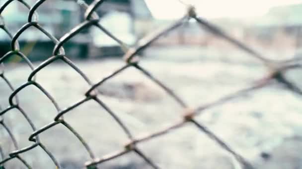 The camera behind the bars moves along the fence on the street — Stok Video