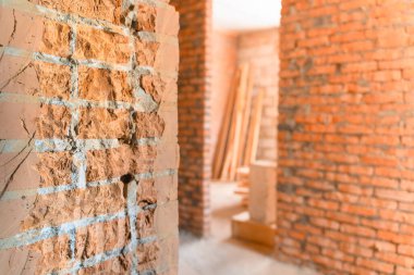 Broken brick wall close-up. Demolition of a wall in a private house. Dismantling at a construction site