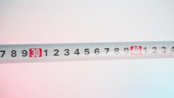 Choosing the right size on the construction tape measure. Measuring tape close-up on a white background — 비디오