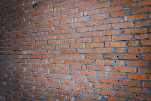Wallpaper from a brick wall. Full screen red brick wall. Building background in perspective