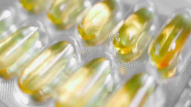 Packaging with fish oil capsules close-up swirling. High quality FullHD footage