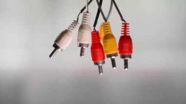 Old rca connectors for audio and video signal transmission close-up on a blurred background. Tulip plug with bad quality bare wires. High quality FullHD footage
