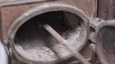 Shoveling ashes with an iron shovel close-up. High quality 4k footage