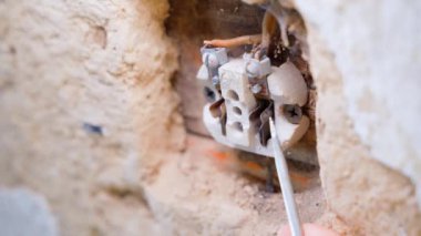 The old electrical outlet of the old generation is picked with a flat screwdriver. Preloading the terminals in the socket. High quality 4k footage